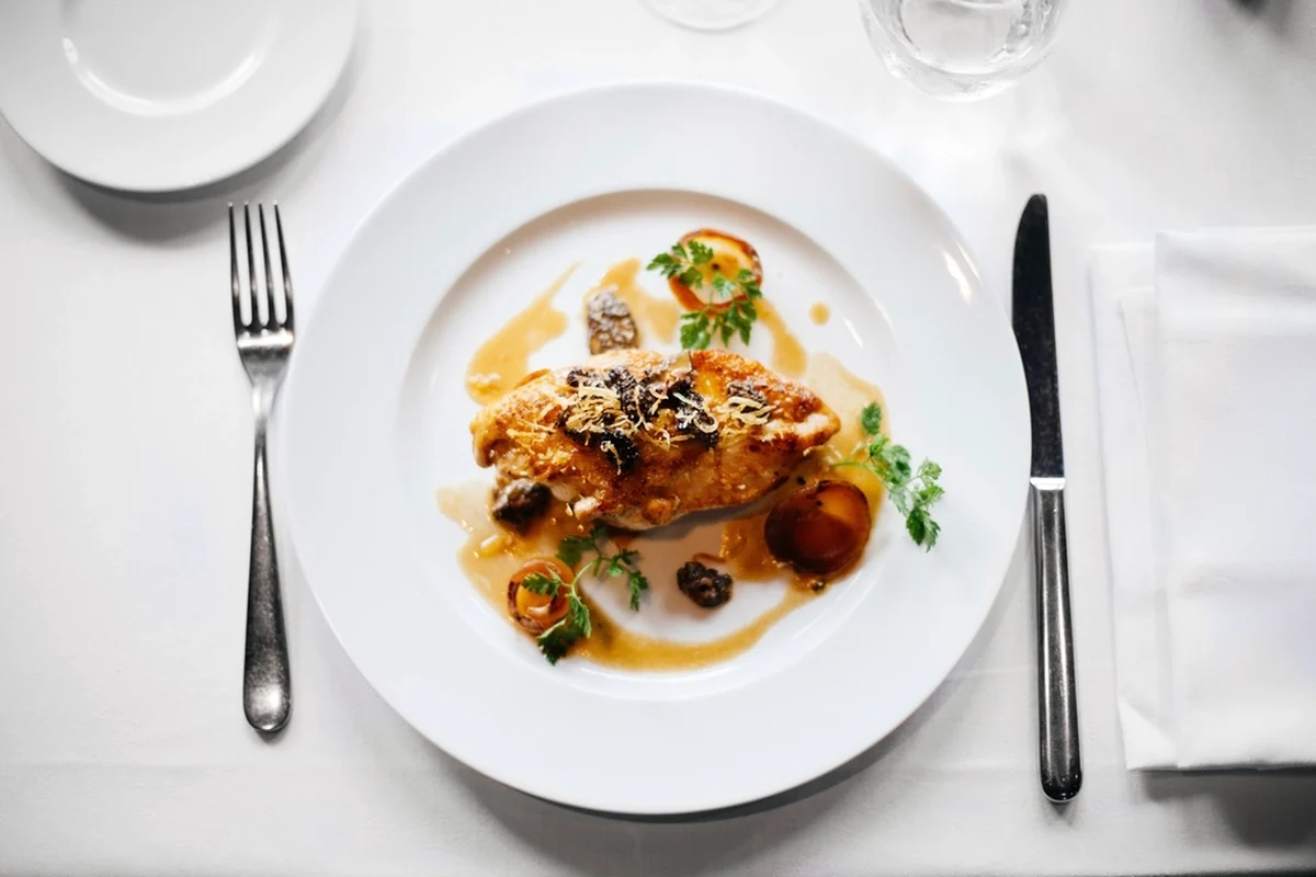 Plated main course at a fine dining table